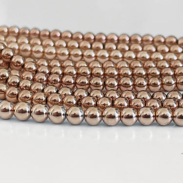 Hæmatit perler i lys rosaguld – ca. 4 mm, hel streng