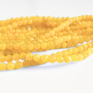 Gule Manshan jade perler – 4 mm, glat og farvet