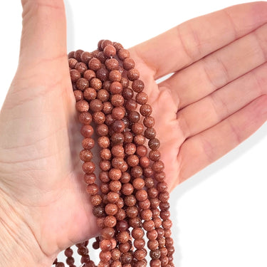 6 mm Goldstone perler - Hel streng